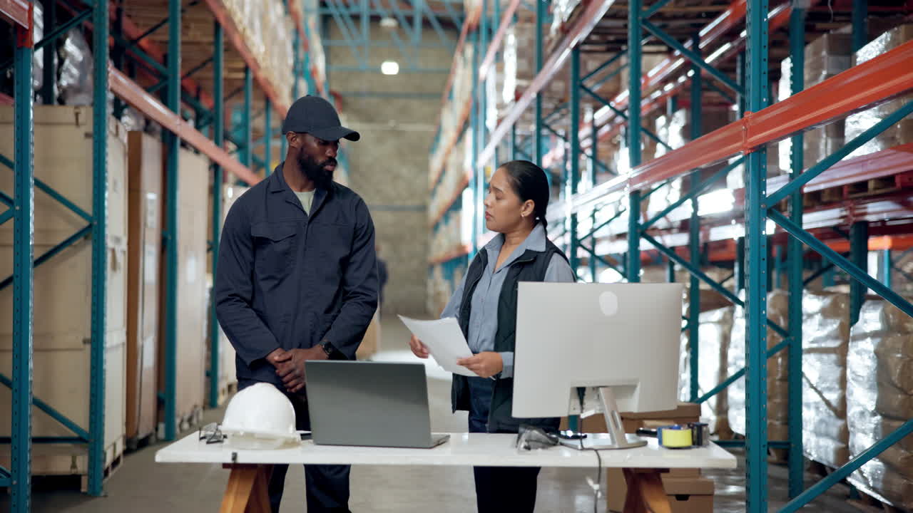 Warehouse workers discussing inventory