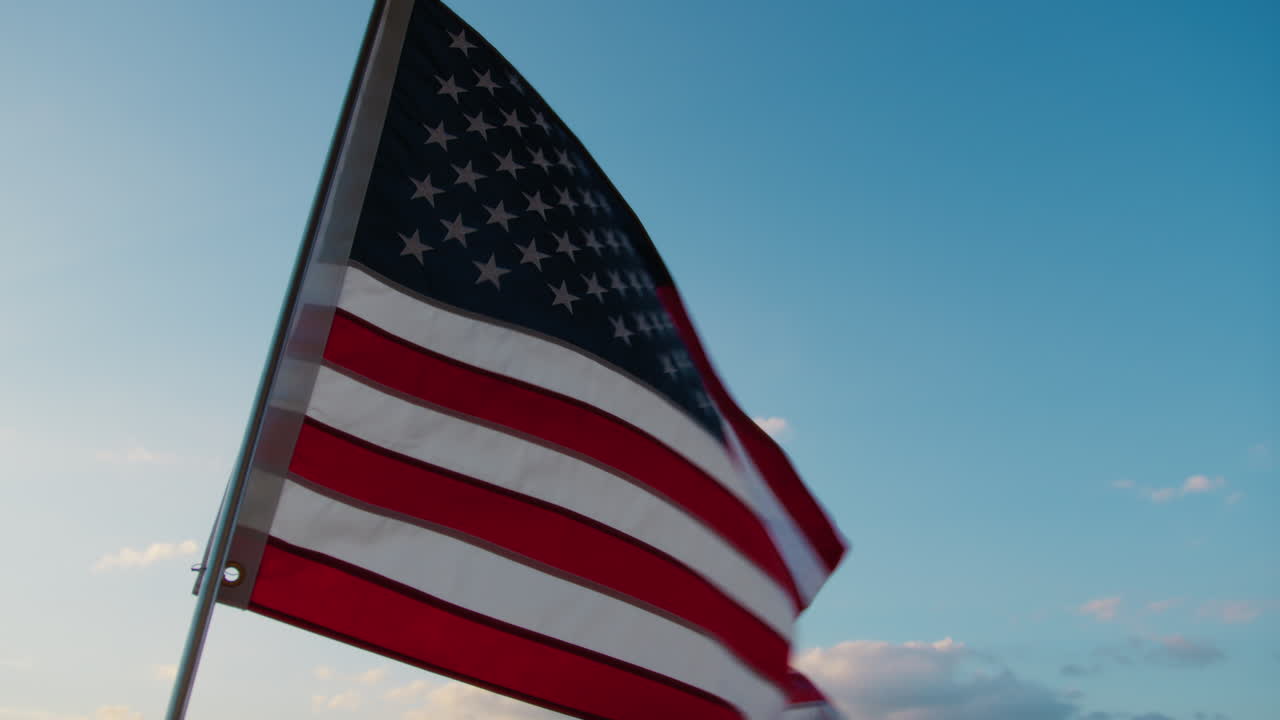 American Flag Waving In The Sky In The Evening After Sunset