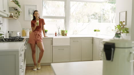 woman in cozy kitchen standing by counter, enjoying peaceful morning moment