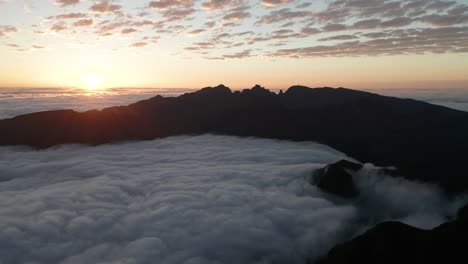 Dichoso-Amanecer-Con-Nubes-Terrestres-Y-Montañas-Creando-Una-Escena-Celestial,-Drone