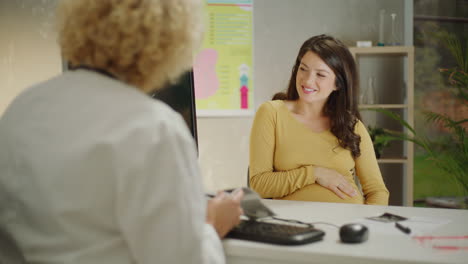 doctor discussing ultrasound with pregnant patient