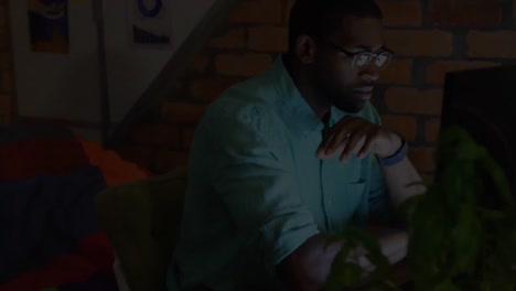 Animation-of-african-american-businessman-using-computer-in-office