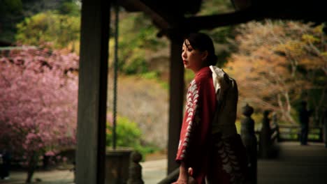woman in kimono at a japanese temple during cherry blossom season