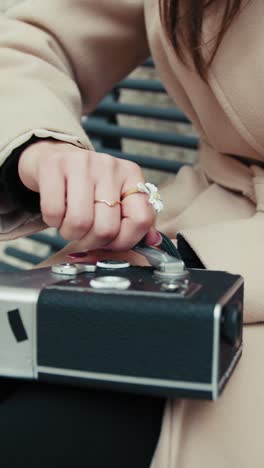 woman preparing the analog camera for shooting close up