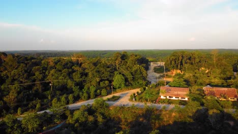 Amazing-cinematic-4K-sunset-residential-drone-footage-after-deforestation-issue-consists-of-homes,-road,-trees,-lake-and-infrastructure-in-the-middle-of-tropical-forest-located-in-Riau,-Indonesia