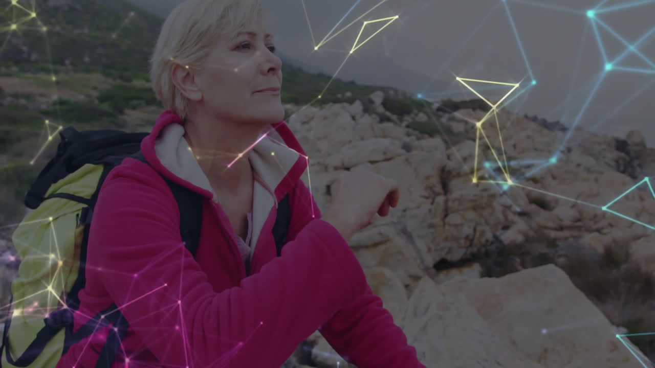 Woman sitting on rocky hill, carrying yellow pack, showing glowing network lines for tech marketing