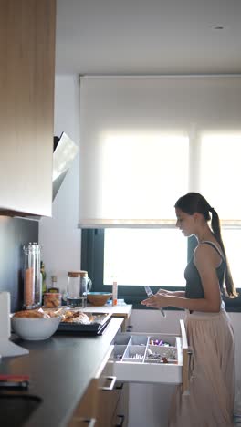 teenage girl in a modern kitchen preparing food