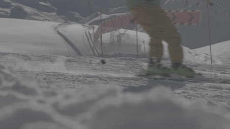 slowmotion shot of a skier passing by on the slopes with orange warning signs in the background on a sunny day log