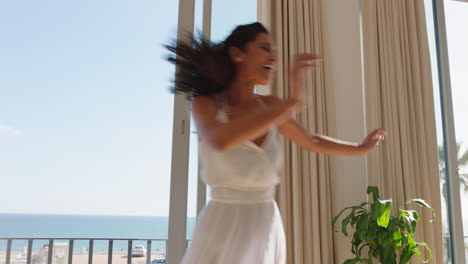 travel woman dancing in hotel room having fun celebrating summer vacation enjoying carefree holiday lifestyle