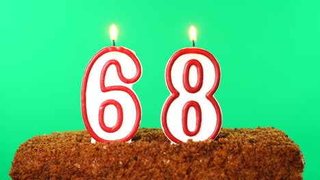 cake with the number 68 lighted candle. chroma key. green screen. isolated