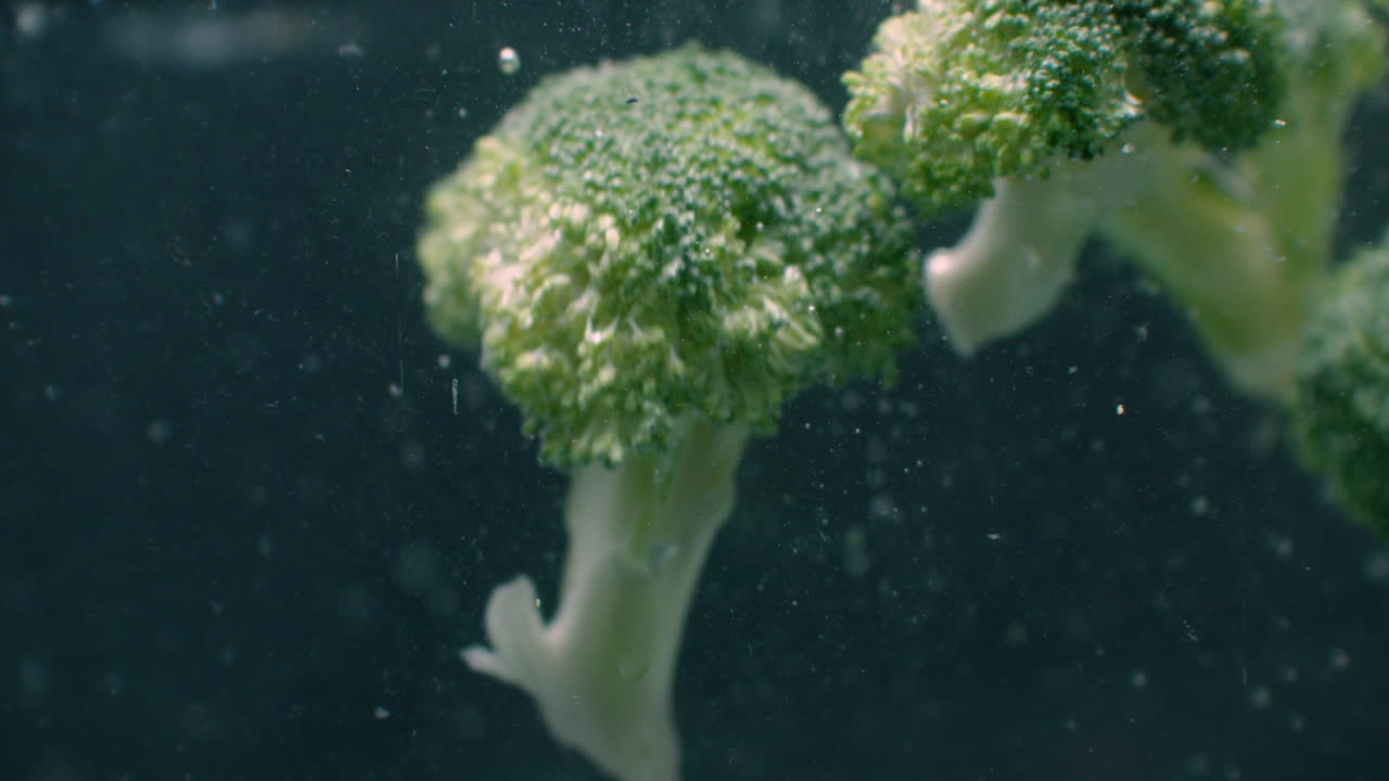 Broccoli Under water with air bubbles and in slow motion. Fresh and juicy healthy vegetarian product.