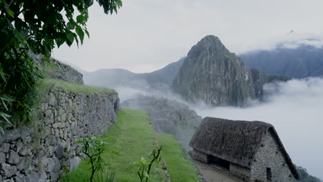 zoom out of machu picchu and huayna picchu in cold rainy morning. lost city inca citadel. establishing