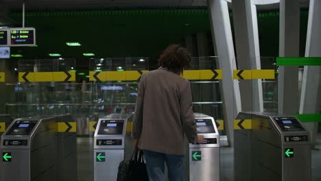 person using turnstile in a metro station