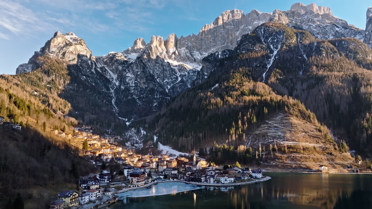 Aerial drone view of the Alleghe village with Lake Alleghe, in the province of Belluno, Dolomites, Italy