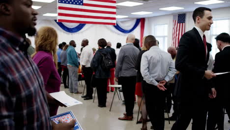 a diverse group of people attending a political or community gathering indoors, decorated with patriotic themes