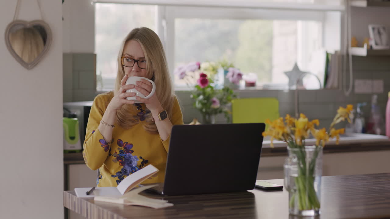 Woman working from home in kitchen