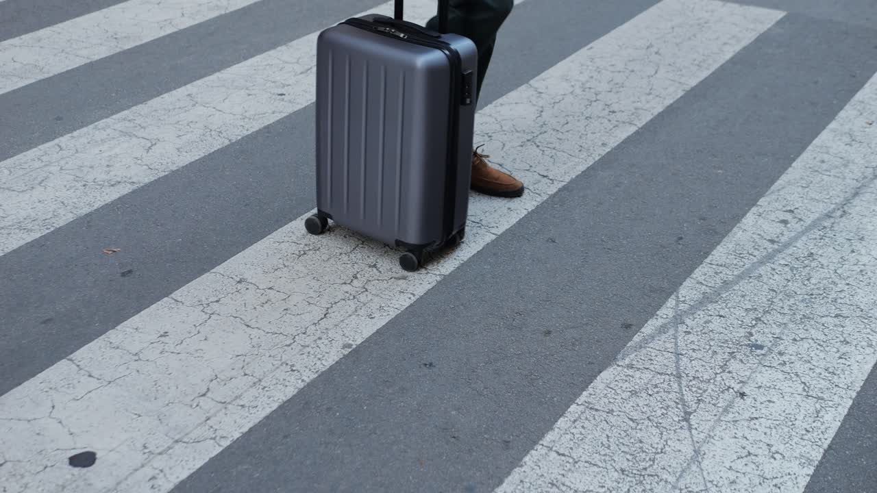 Person Walking Across Crosswalk with Luggage