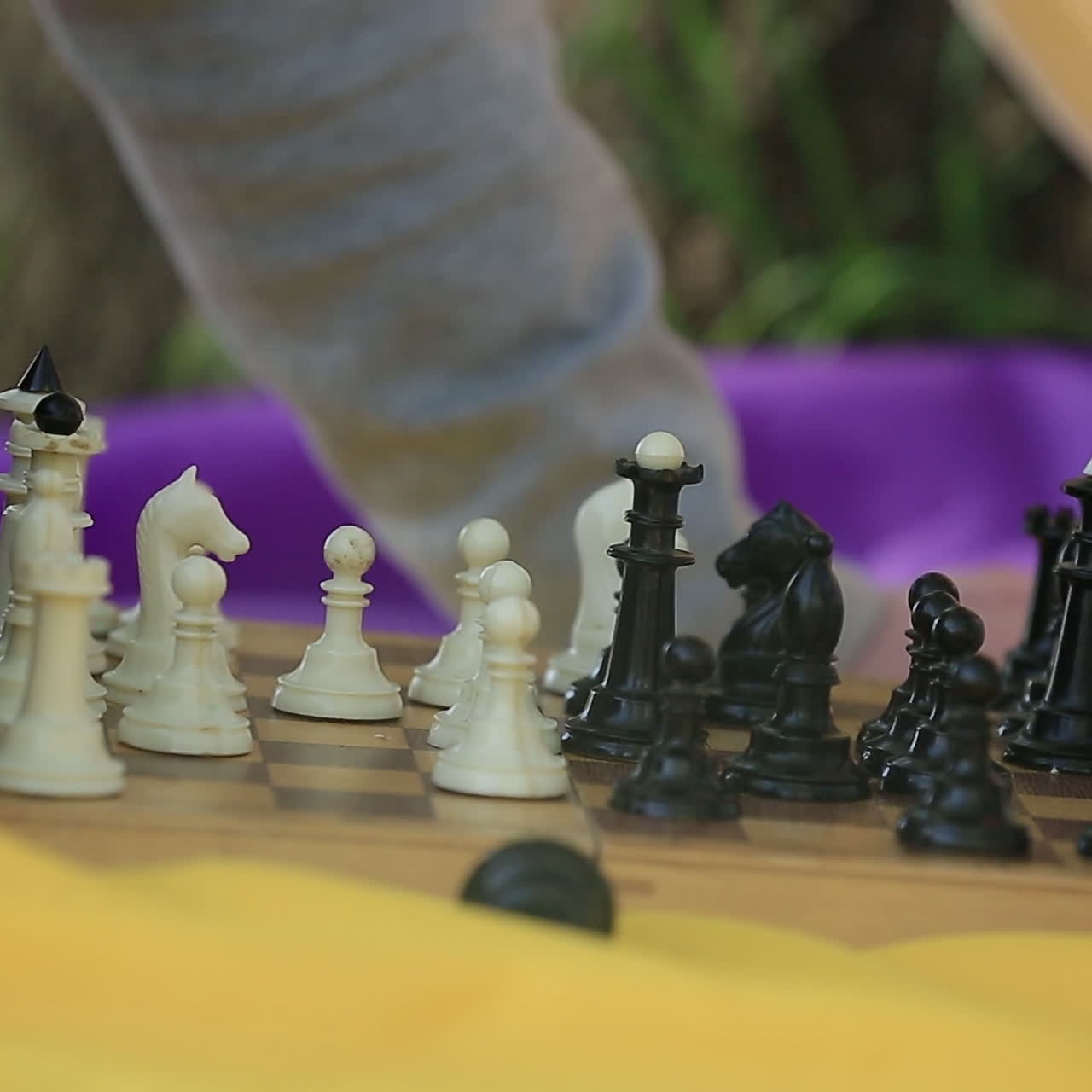 Man and woman playing chess. Chess pieces on the board.