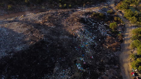 Huge-mountains-of-plastic-waste-dumped-in-the-middle-of-Cambodia's-nature-while-part-of-it-still-smokes-after-being-burned