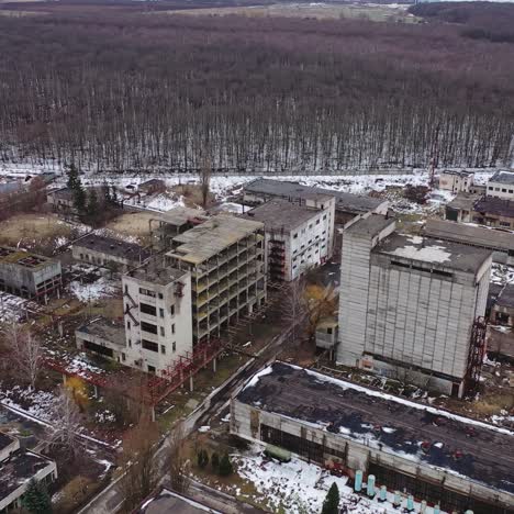 large territory of abandoned factory. old industrial buildings for demolition. ruined industrial zone on nature background. aerial view