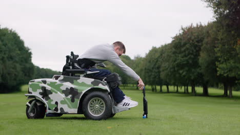 man playing golf from a wheelchair