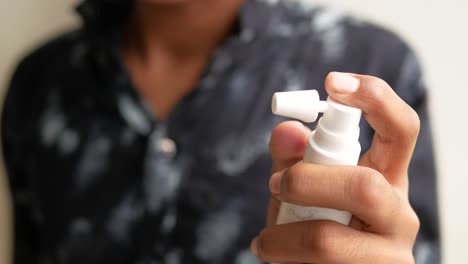 person using nasal spray