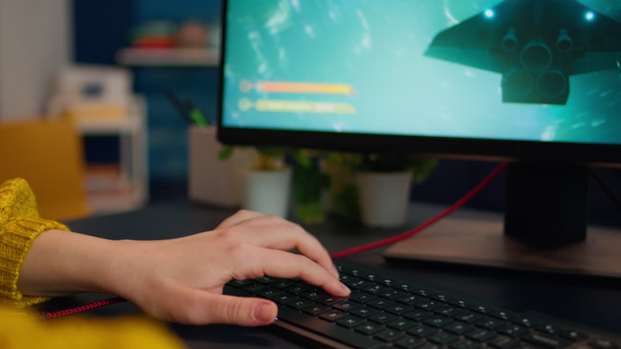 Close up hands shot of gamer pushing the keyboard buttons