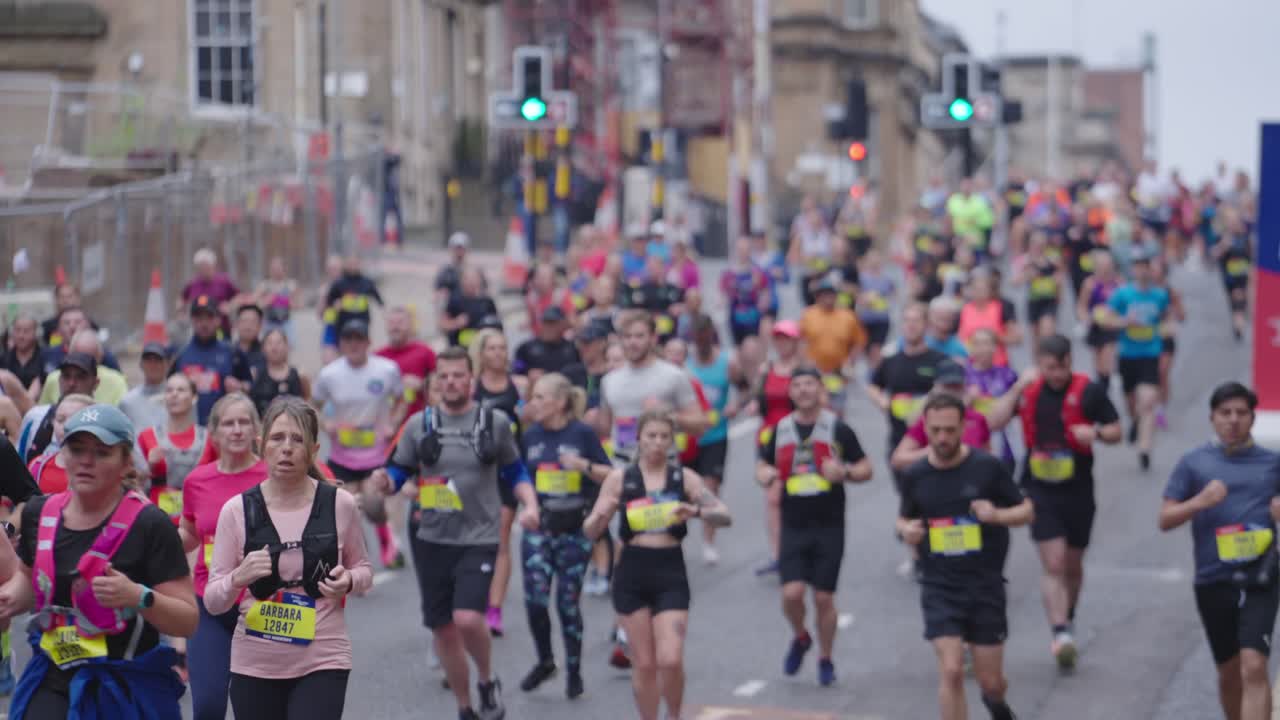 Urban charity event, people running for good causes, slow motion