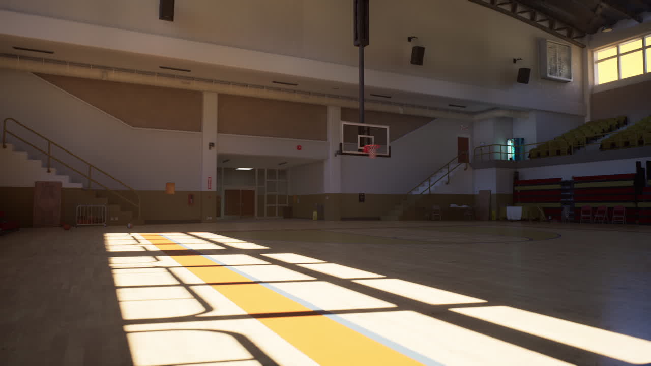 Empty indoor basketball court with bleachers