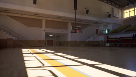 empty indoor basketball court with bleachers