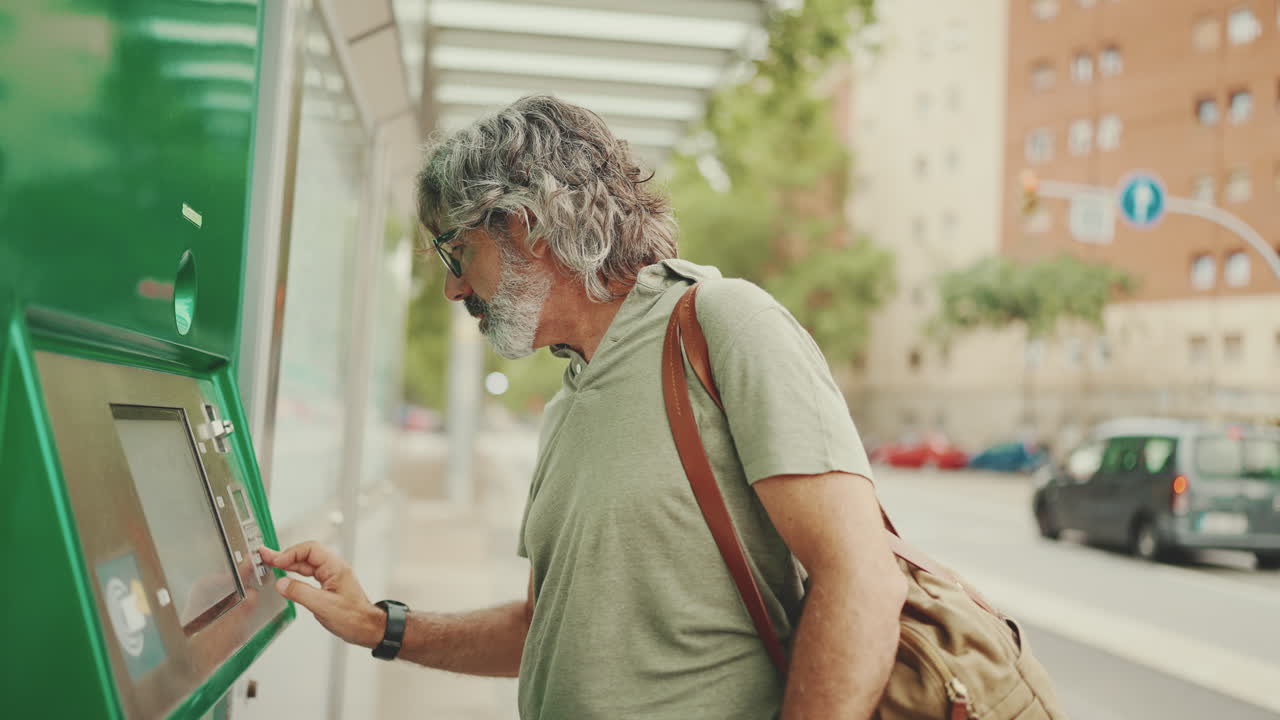 Man buying ticket at ticket machine