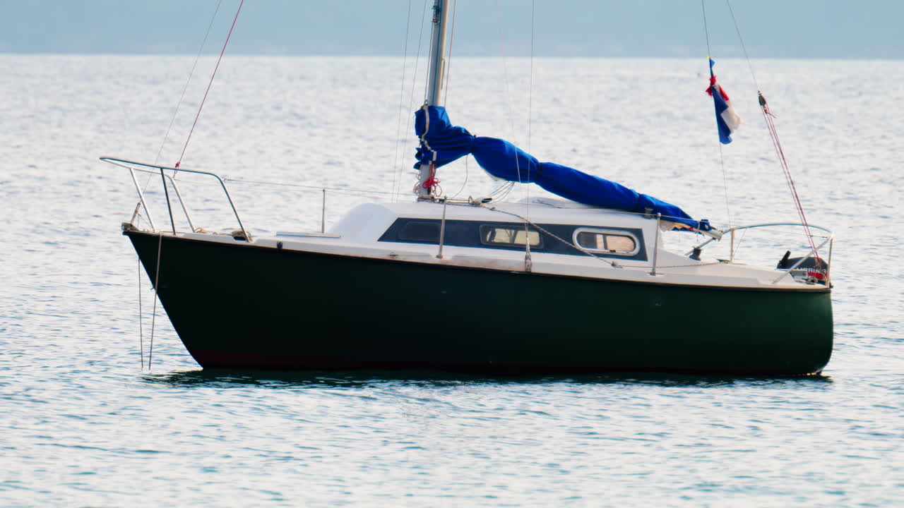 Antibes, France - February 14, 2025: White boat docked on the sea on a cloudy day