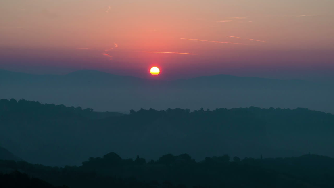 Sunrise time lapse over hills and mountains