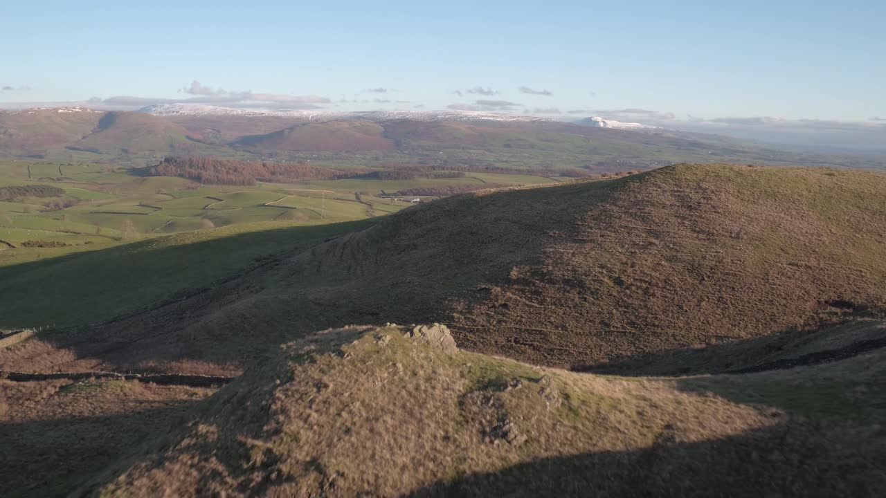 Aerial view over Scout Hill in the South Lakes looking North towards the snow covered peaks of the Lake District in the United Kingdom