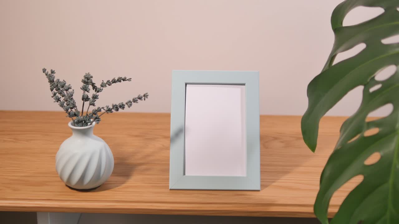 Minimalist home decor with frame, vase, and plant