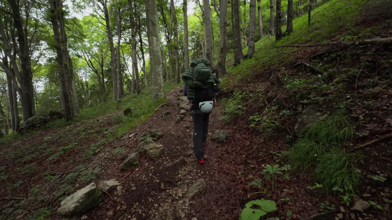 Lombardy, Italy - A Mountaineer Navigating Through the Forested Slopes of Grignetta - Handheld Shot
