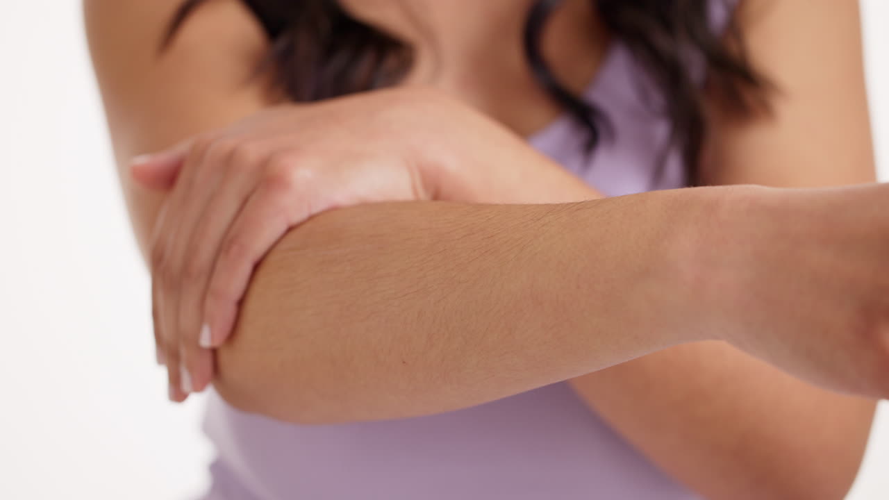 Woman applying moisturizer to arm
