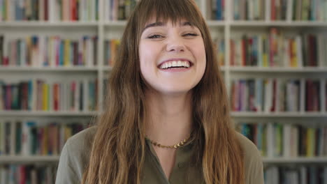 close up portrait of young happy caucasian woman laughing cheerful cute librarian in library bookshelf background