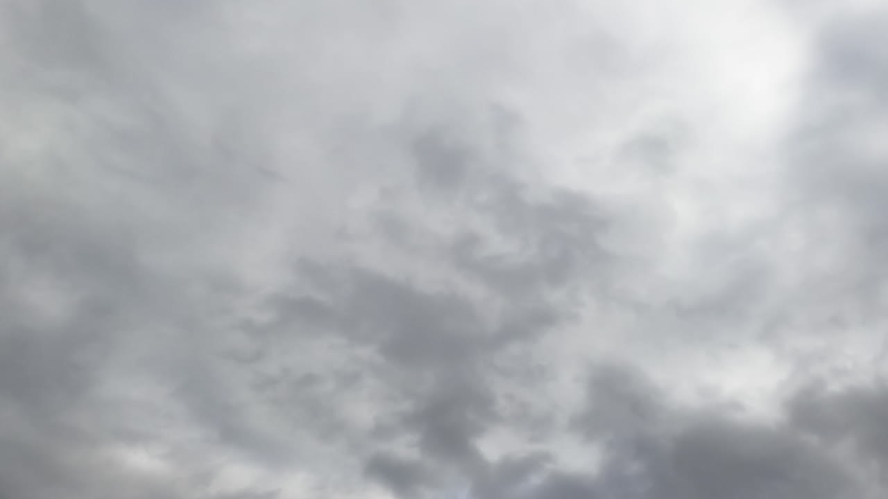 Skies can't be seen because of grey cloudscape coating the horizon. Low angle view. Timelapse.