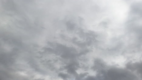 skies can't be seen because of grey cloudscape coating the horizon. low angle view. timelapse.