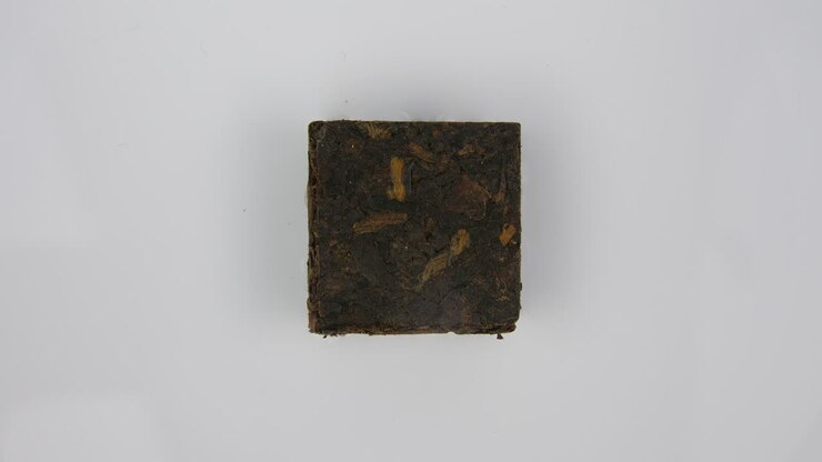 Stop motion: close up of absorption of liquid by isolated tea cube, background