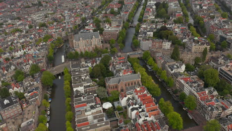 Typical-Amsterdam-Neighbourhood-with-Church-wide-Establisher,-Aerial-forward,-Cloudy