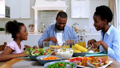 family having meal on dinning table at home