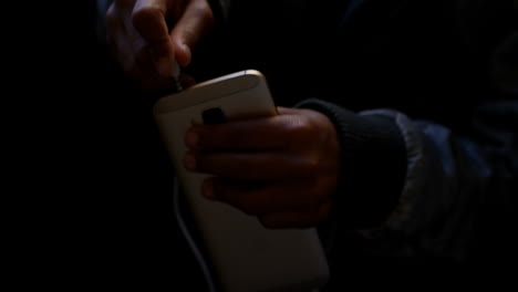 commuter inserting earphones jack on mobile phone while travelling in bus 4k