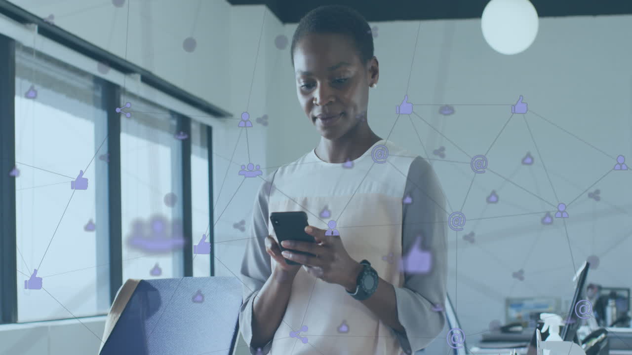 Animation of connected icons over african american woman using cellphone in office