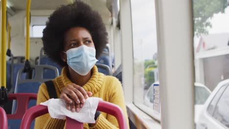 African-american-businesswoman-with-face-mask-sitting-in-bus