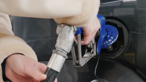 man refuels his car at a gas station 03