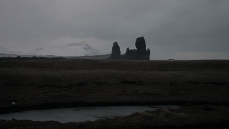 icelandic winter landscape with snow-covered mountains and dark volcanic rocks