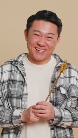 magician witch asian man gesturing with magic wand making wish come true casting magician spell