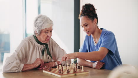 Elderly woman playing chess with a caretaker
